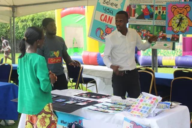 Eazi Education stand at an exhibition, with wall charts on display